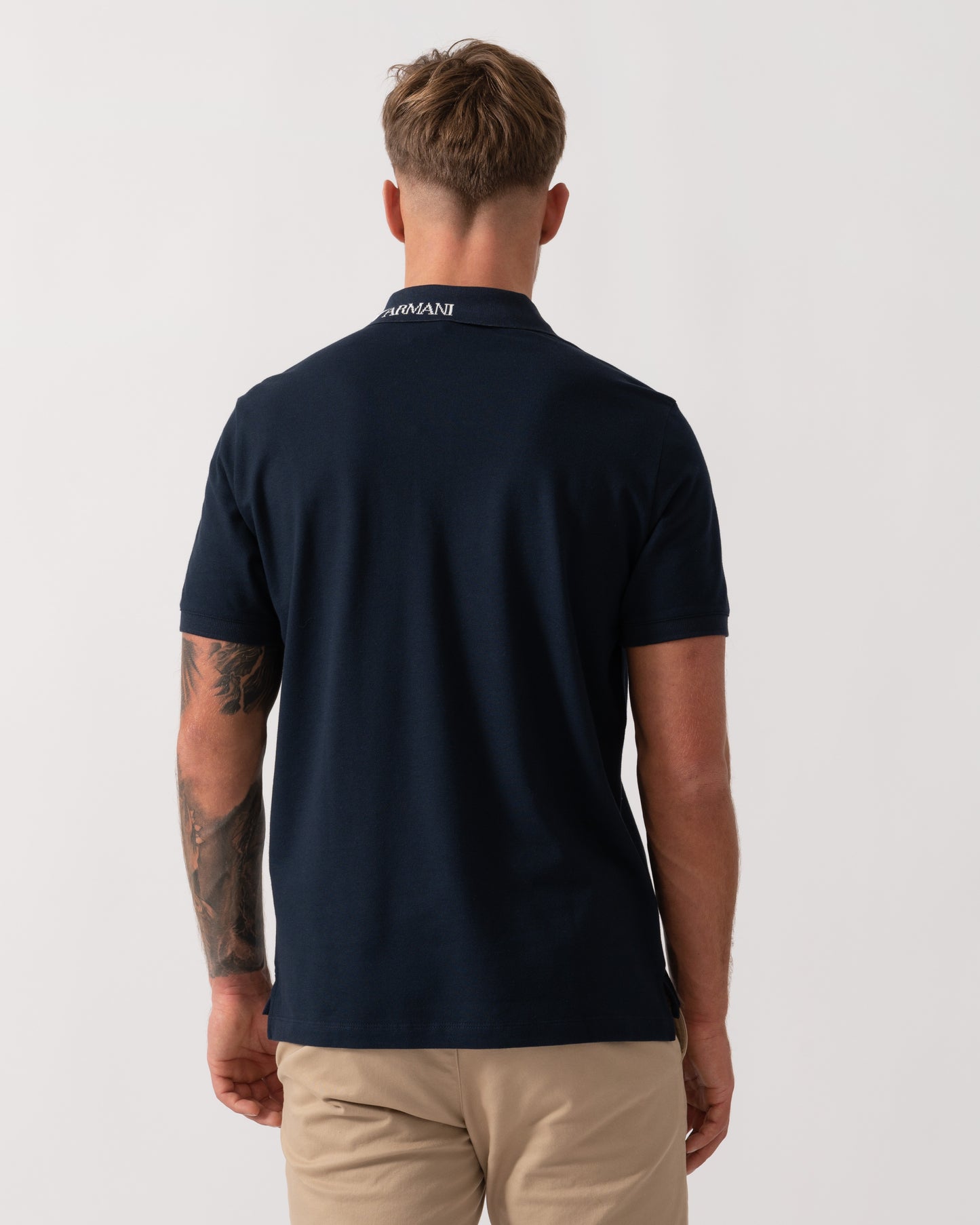 Model wearing Emporio Armani Mens Beach Polo in Armani Blue - Back