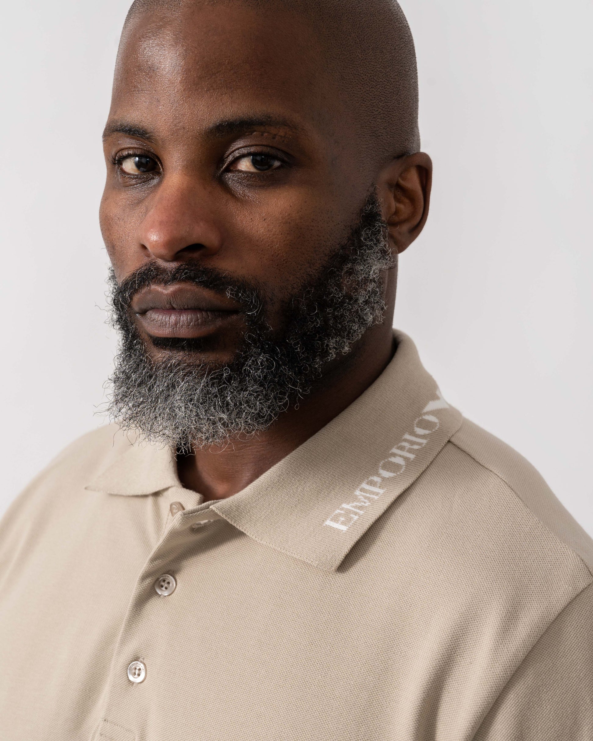 Model wearing Emporio Armani Mens Beach Polo in Taupe - Collar Detail