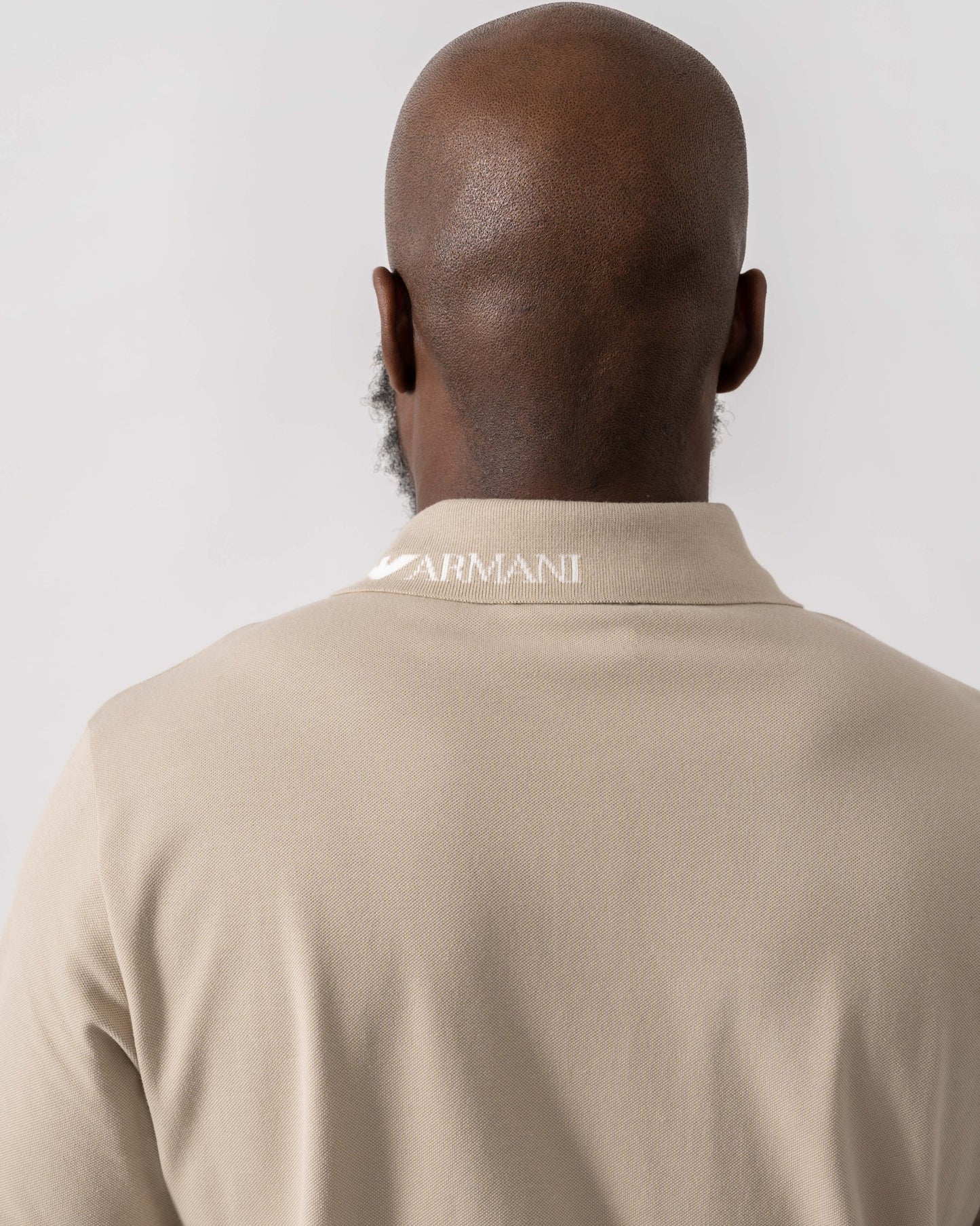 Model wearing Emporio Armani Mens Beach Polo in Taupe - Back 