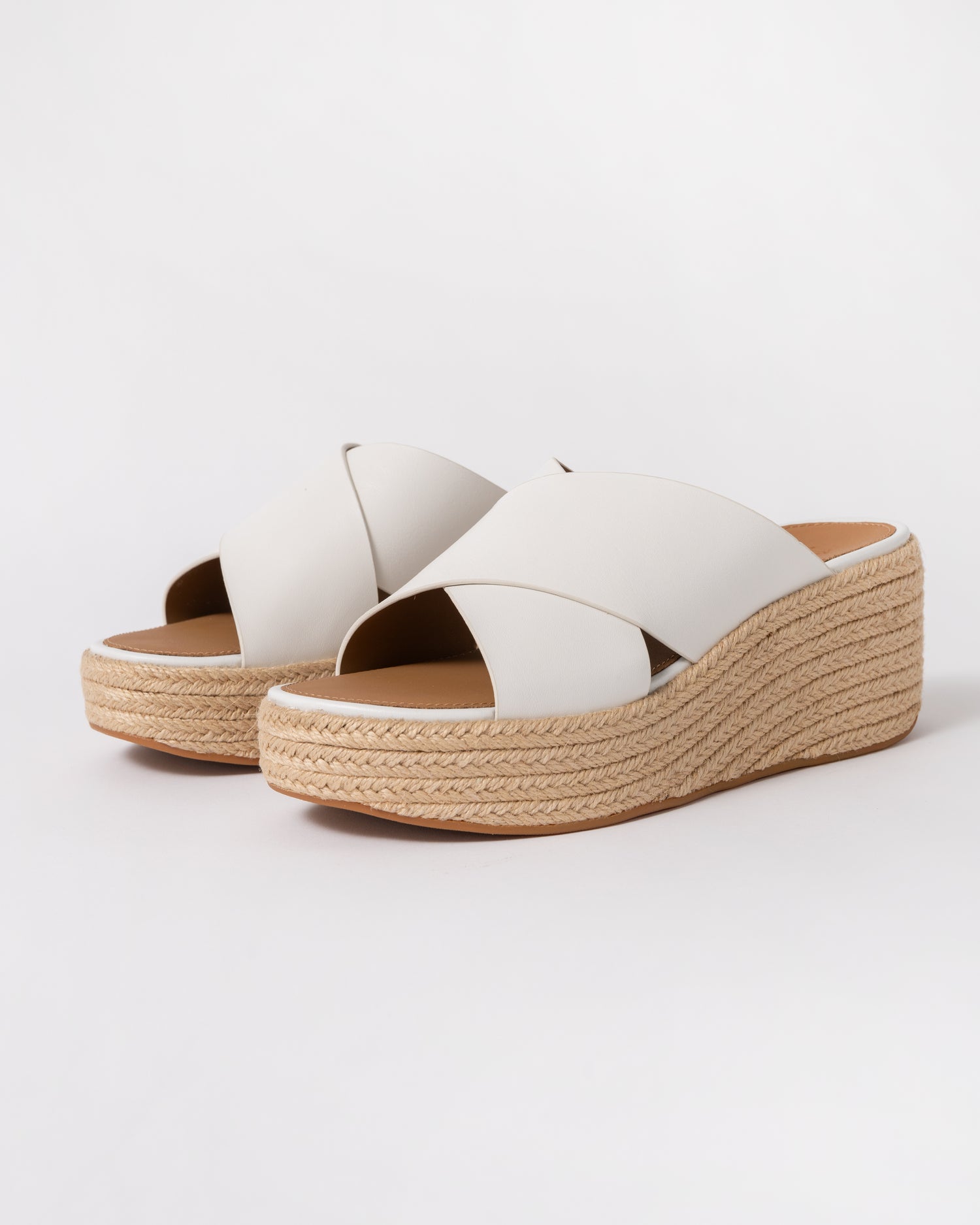 a pair of FitFlop Womens PLATFFORMS Espadrille Leather Wedge Cross Slides in Urban White 194
