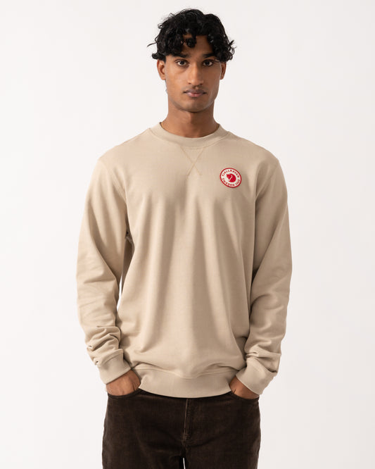 studio photograph showing a model wearing a Fjallraven 1960 Logo Badge Mens Sweatshirt in Fossil 118