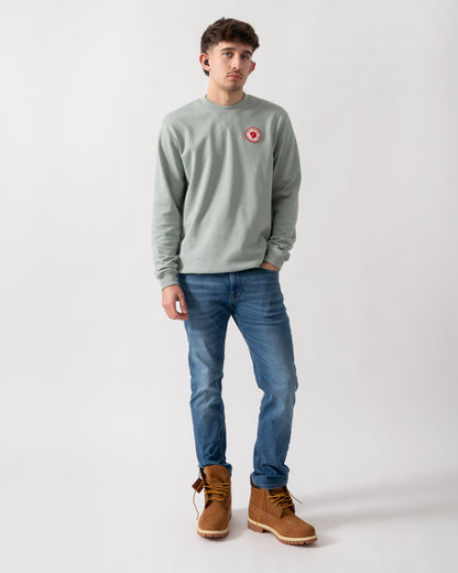 full length shot of a model wearing a Fjallraven 1960 Logo Badge Mens Sweatshirt in Misty Green 674