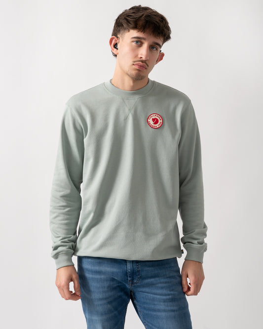 studio shot of a model wearing a Fjallraven 1960 Logo Badge Mens Sweatshirt in Misty Green 674
