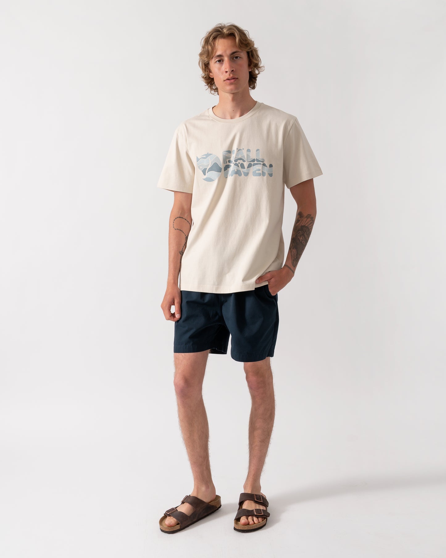 full length shot of a model wearing a Fjallraven Multicolor Logo Mens T-Shirt in Chalk White 113