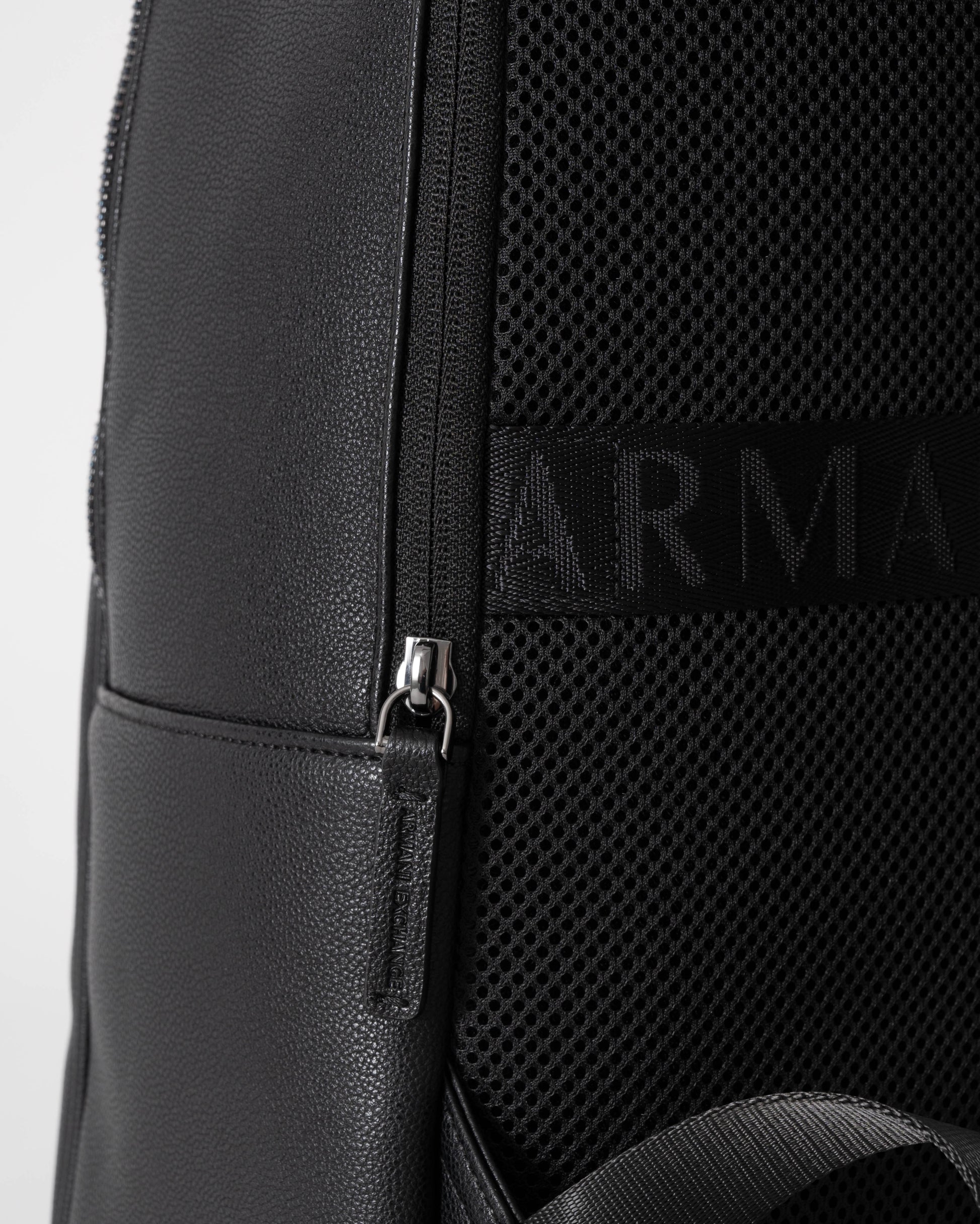 Close-up of a black backpack with a brand logo on a white background