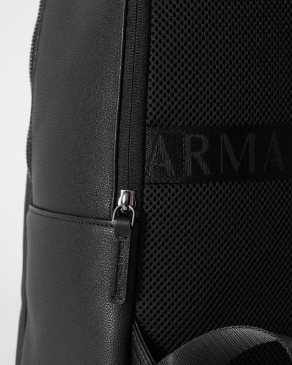 Close-up of a black backpack with a brand logo on a white background