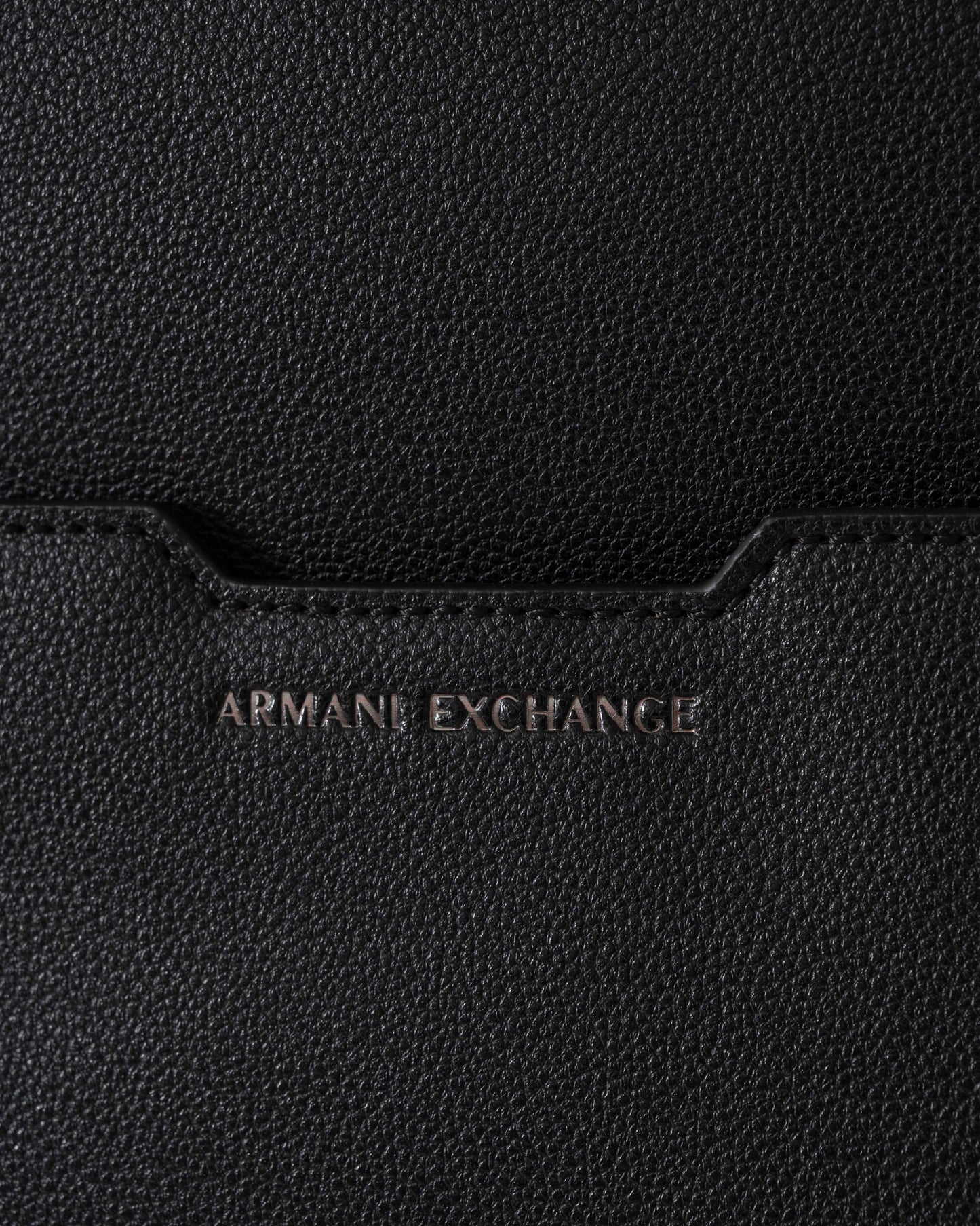 Close-up of a black Armani Exchange bag with brand logo.