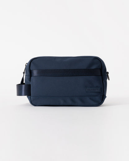 Navy blue bag with a visible brand label on a white background