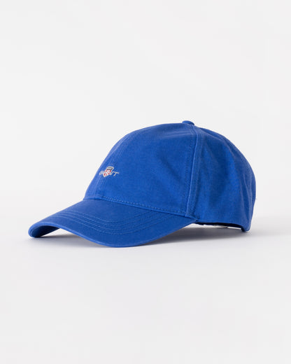 Blue baseball cap on a light gray background