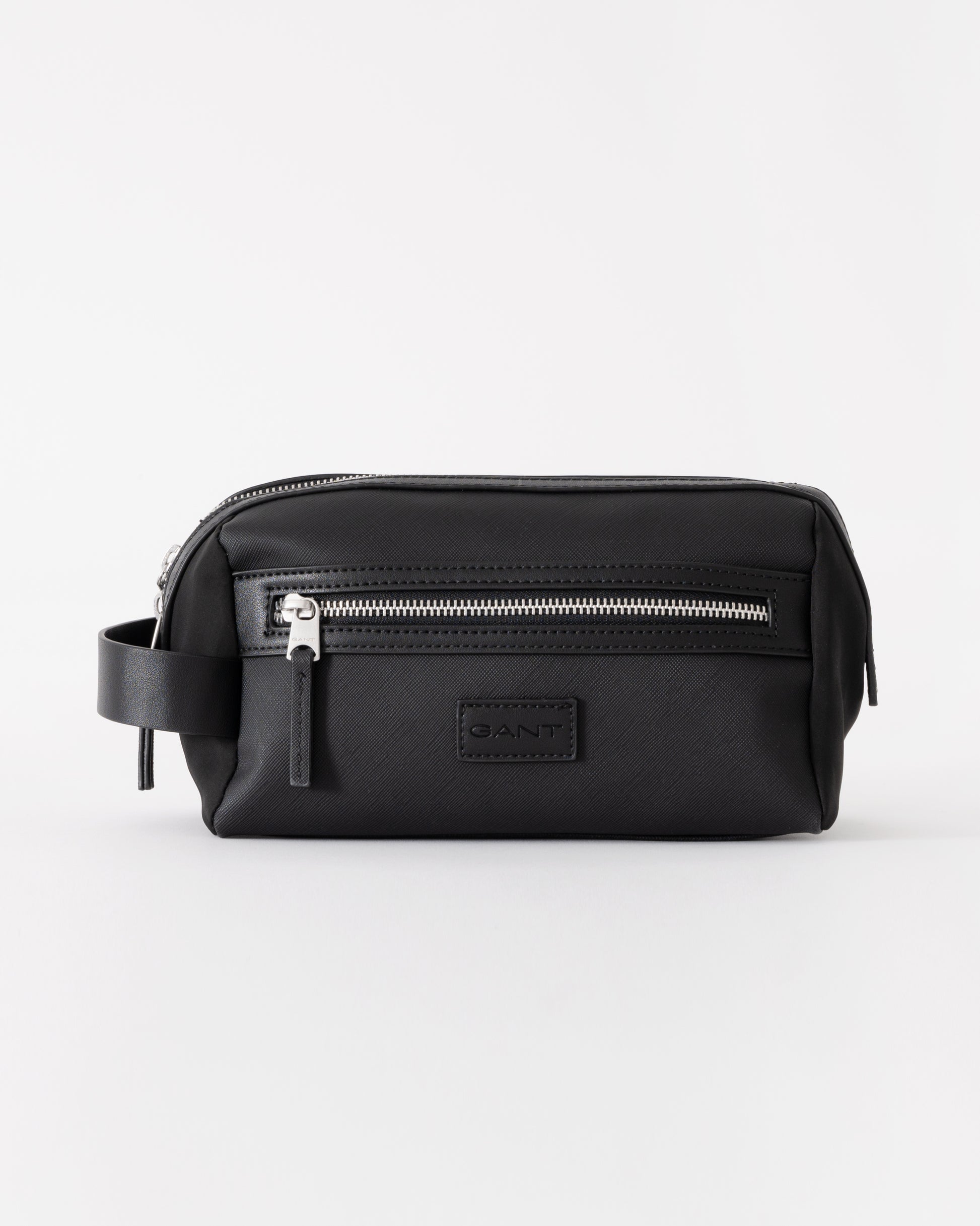 Black toiletry bag with silver zipper on a white background