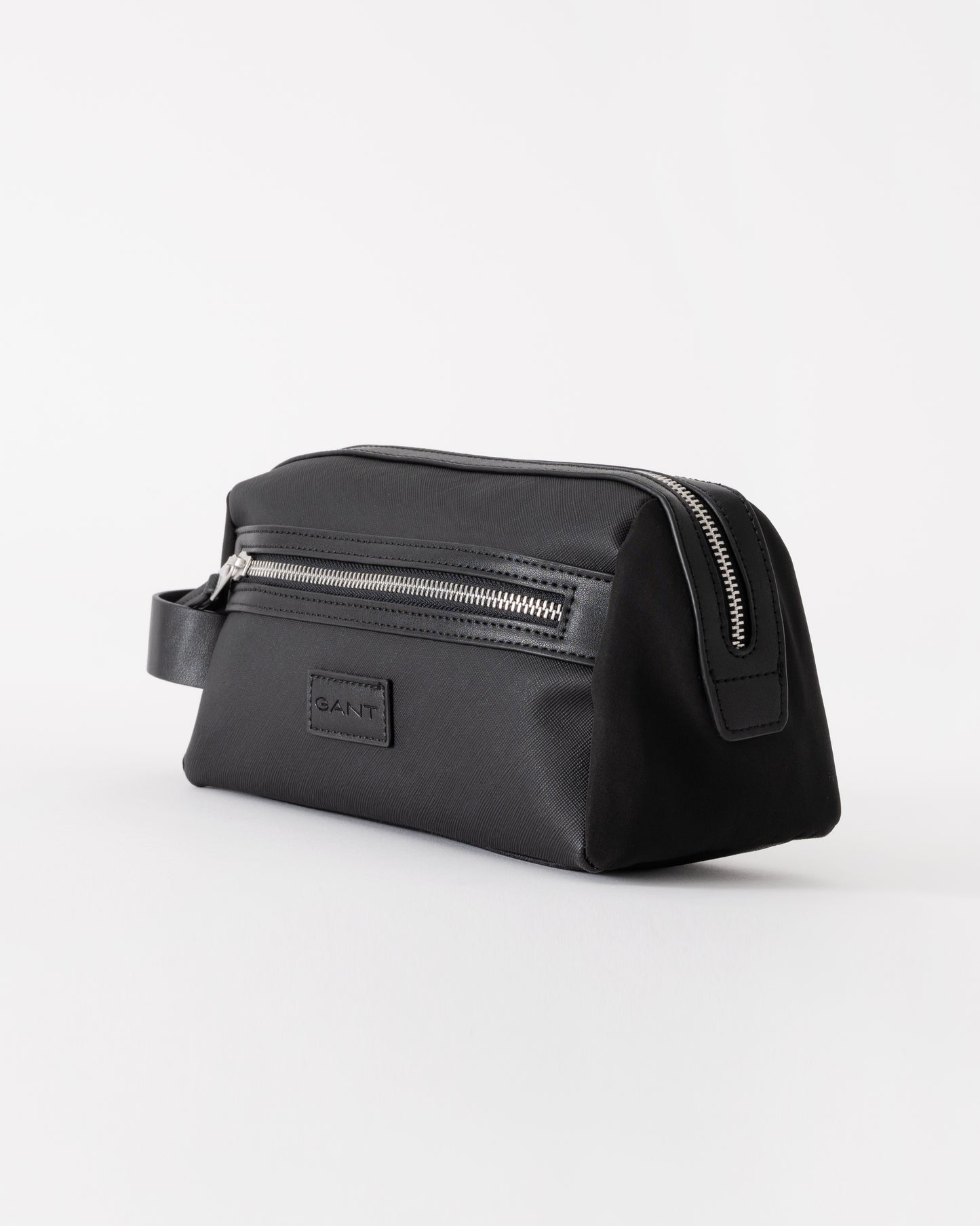 Black toiletry bag with zippers on a white background