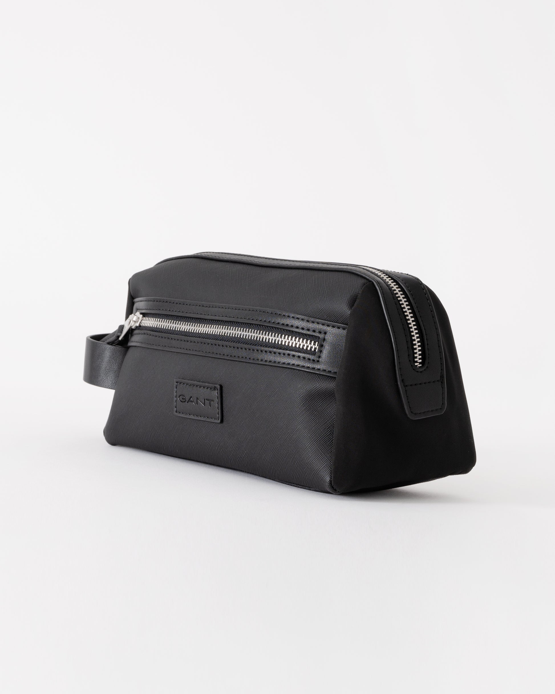 Black toiletry bag with zippers on a white background