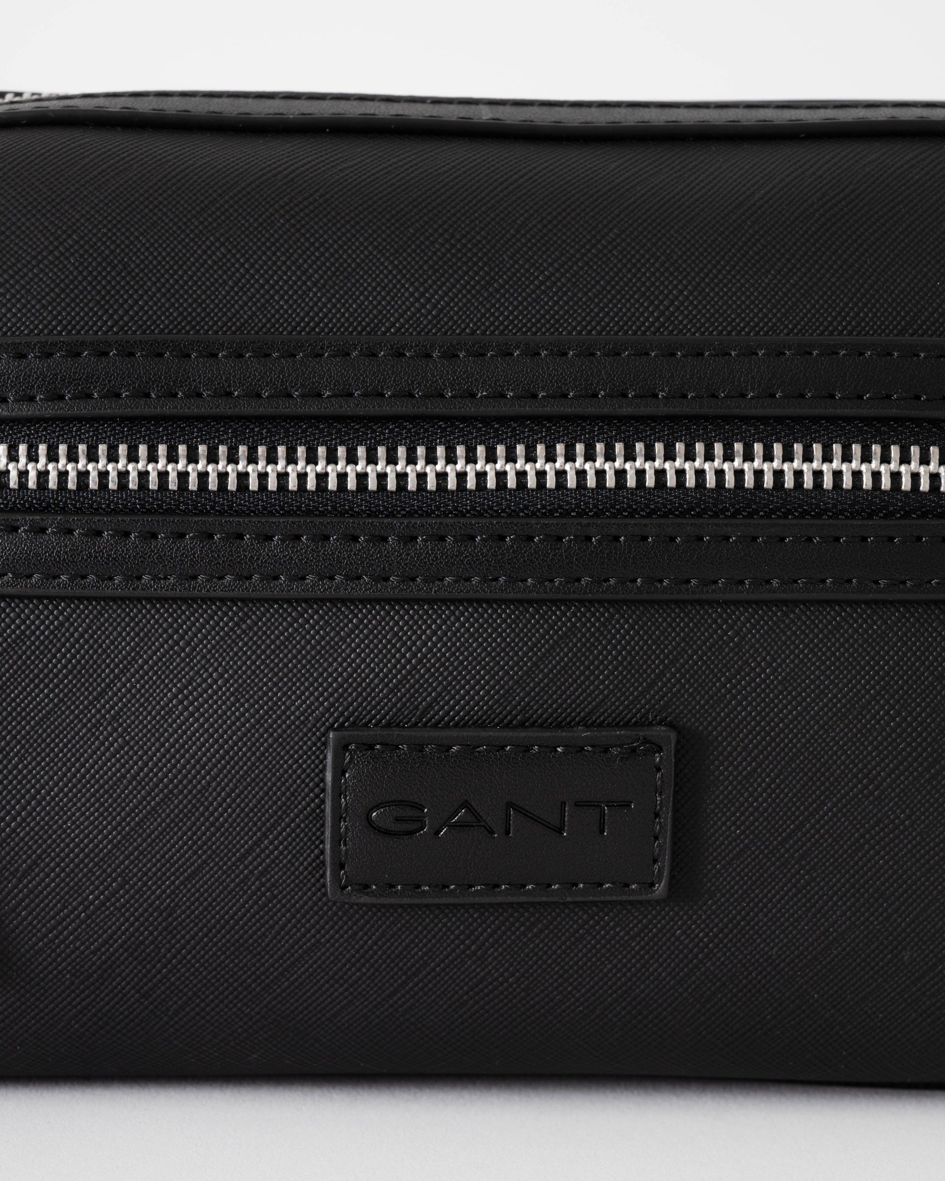 Black Gant bag with a visible brand logo on a white background