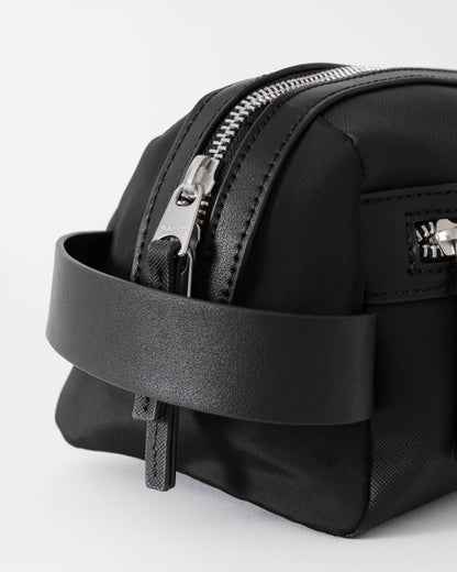 Black backpack with a zipper on a light gray background