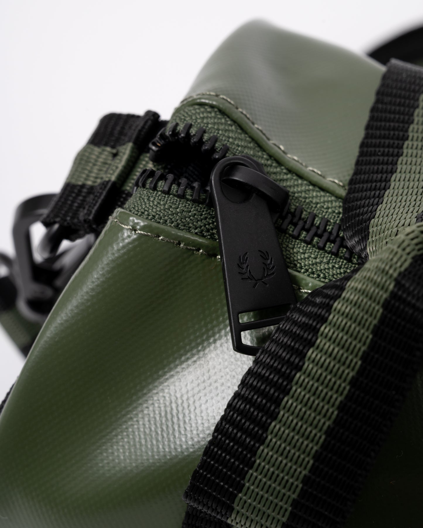zip detail of a Fred Perry Classic Mini Barrel Bag in Laurel Wreath Green and Black Z50