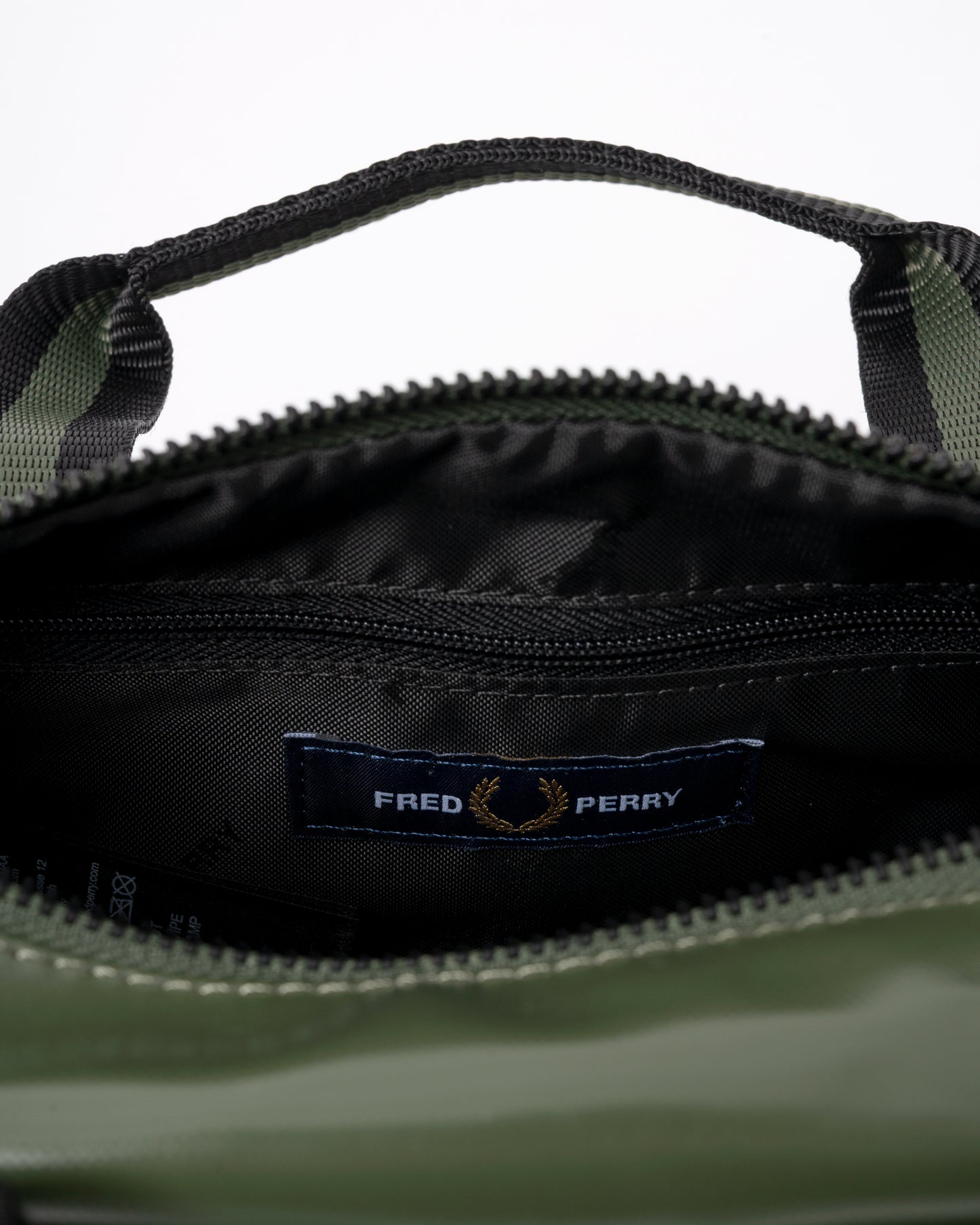 interior detail of a Fred Perry Classic Mini Barrel Bag in Laurel Wreath Green and Black Z50