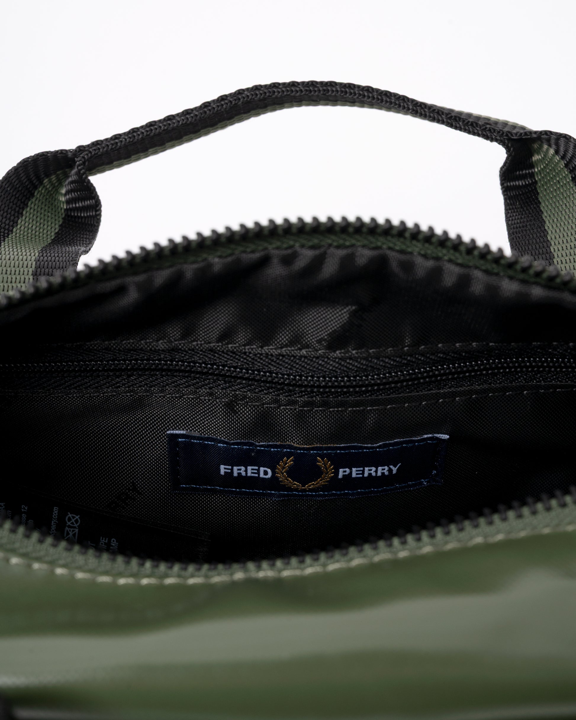 interior detail of a Fred Perry Classic Mini Barrel Bag in Laurel Wreath Green and Black Z50