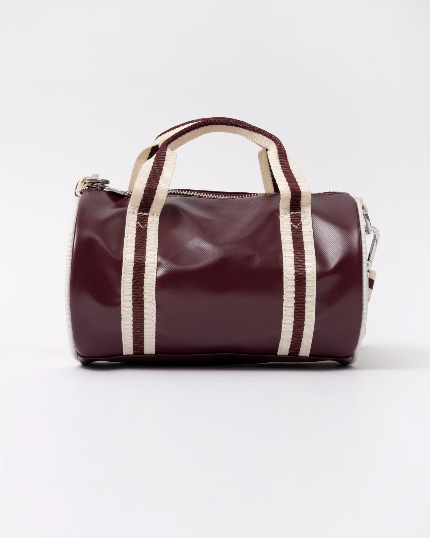 side view of a Fred Perry Classic Mini Barrel Bag in Oxblood and Ecru