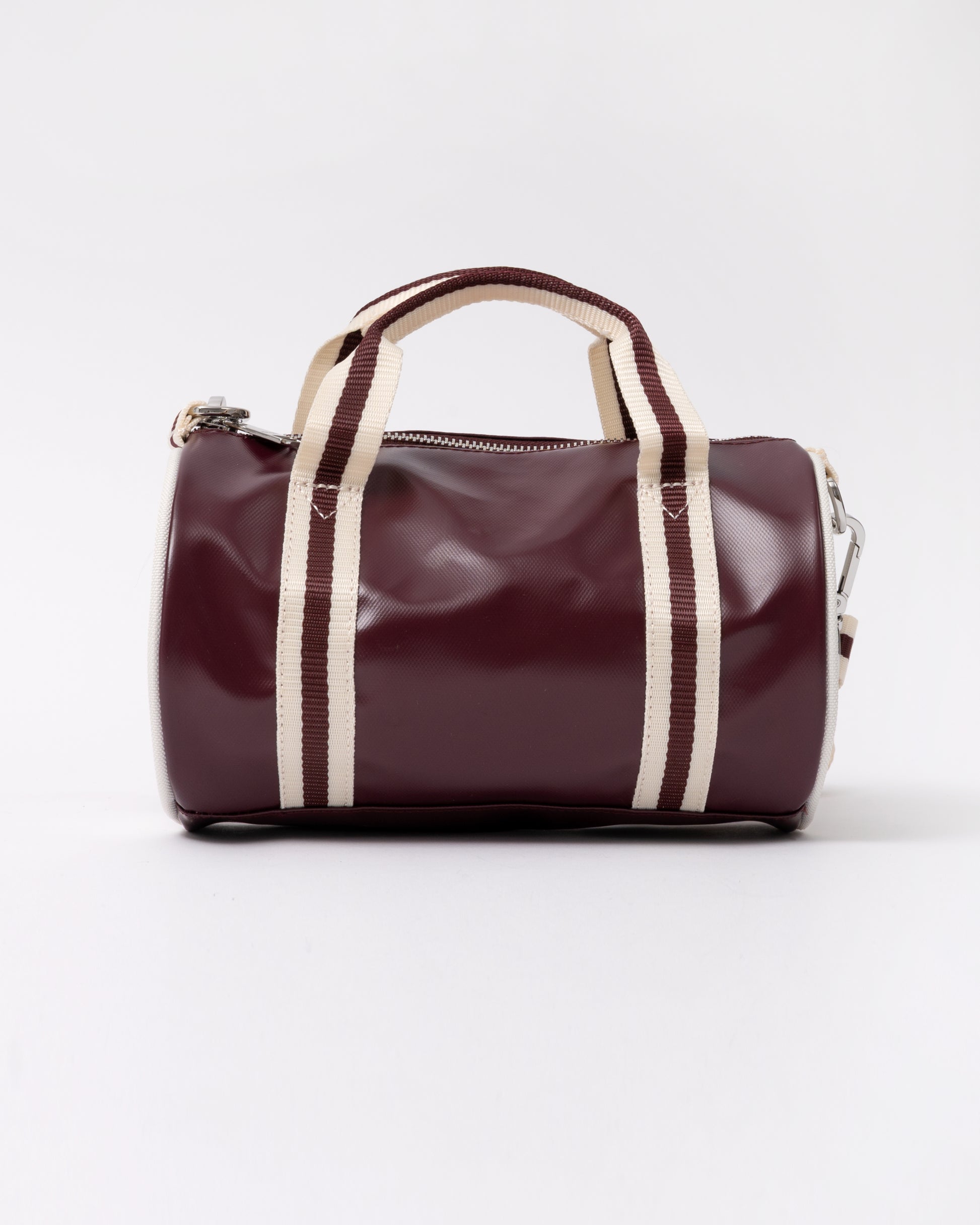 side view of a Fred Perry Classic Mini Barrel Bag in Oxblood and Ecru
