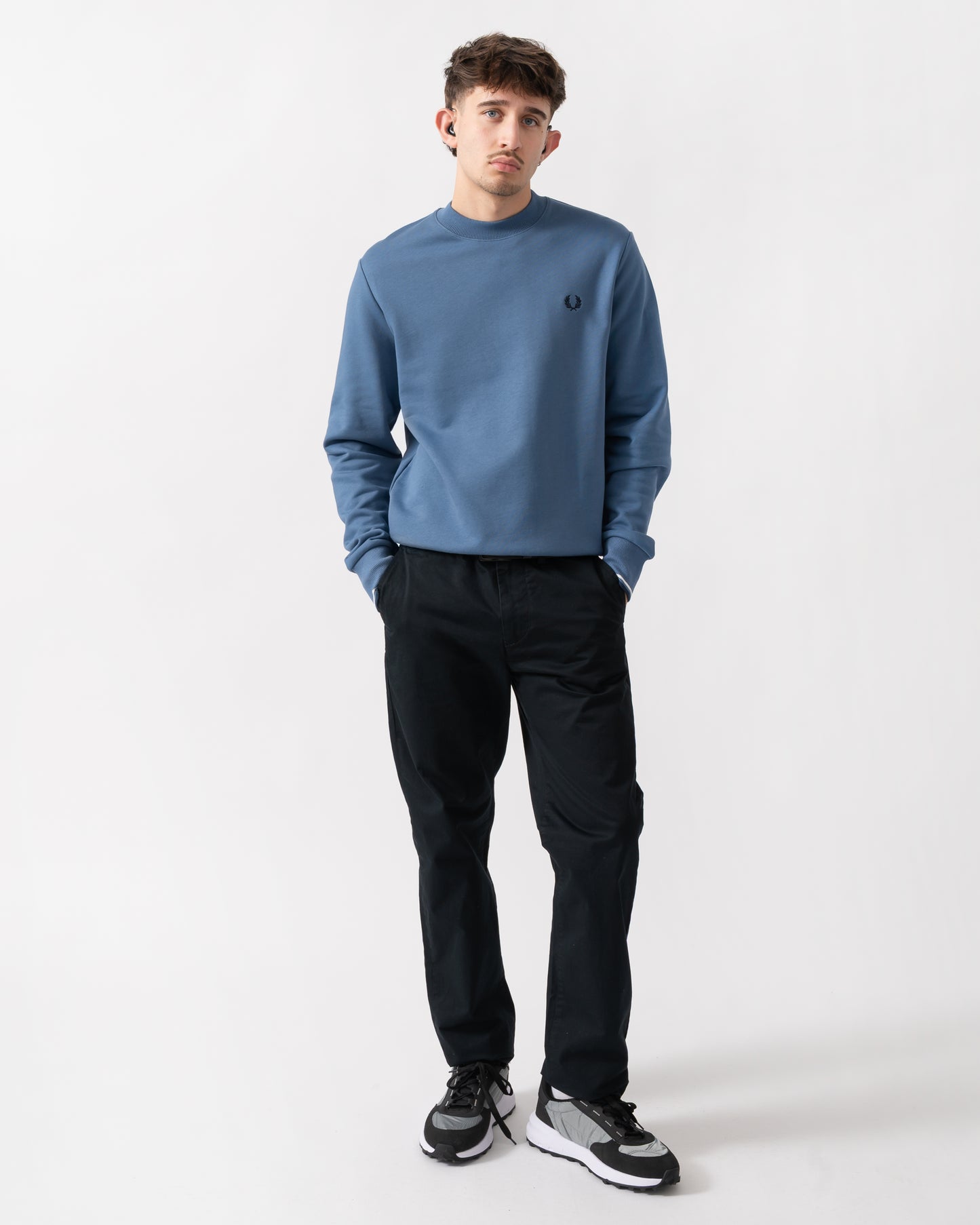 full length shot of a model wearing a Fred Perry Mens Crew Neck Sweatshirt in Ace Blue with Snow White & Tennis Blue trim