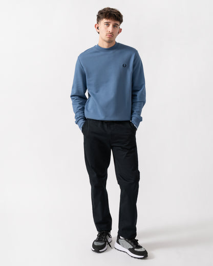 full length shot of a model wearing a Fred Perry Mens Crew Neck Sweatshirt in Ace Blue with Snow White & Tennis Blue trim