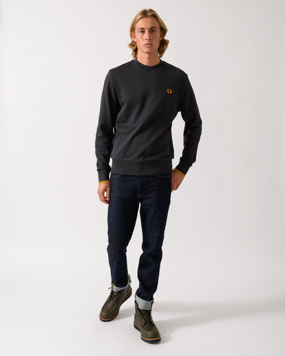 full length studio photograph of a model wearing a Fred Perry Mens Crew Neck Sweatshirt in Anchor Grey/Golden 85C