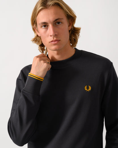 close up studio photograph of a model wearing a Fred Perry Mens Crew Neck Sweatshirt in Anchor Grey/Golden 85C