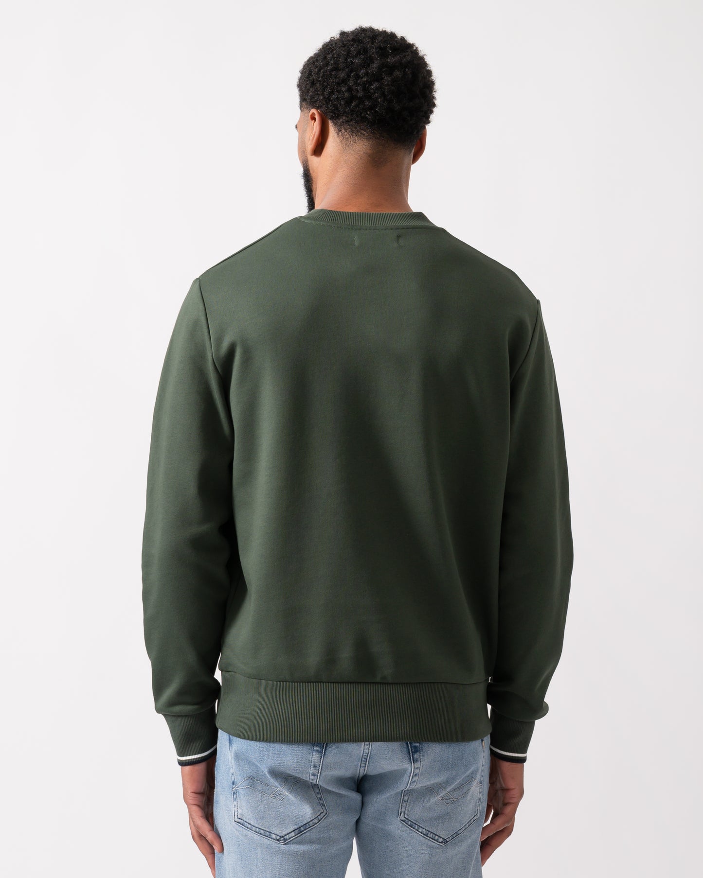 back shot of a model wearing a Fred Perry Mens Crew Neck Sweatshirt in Court Green, with Snow White trim and Navy logo