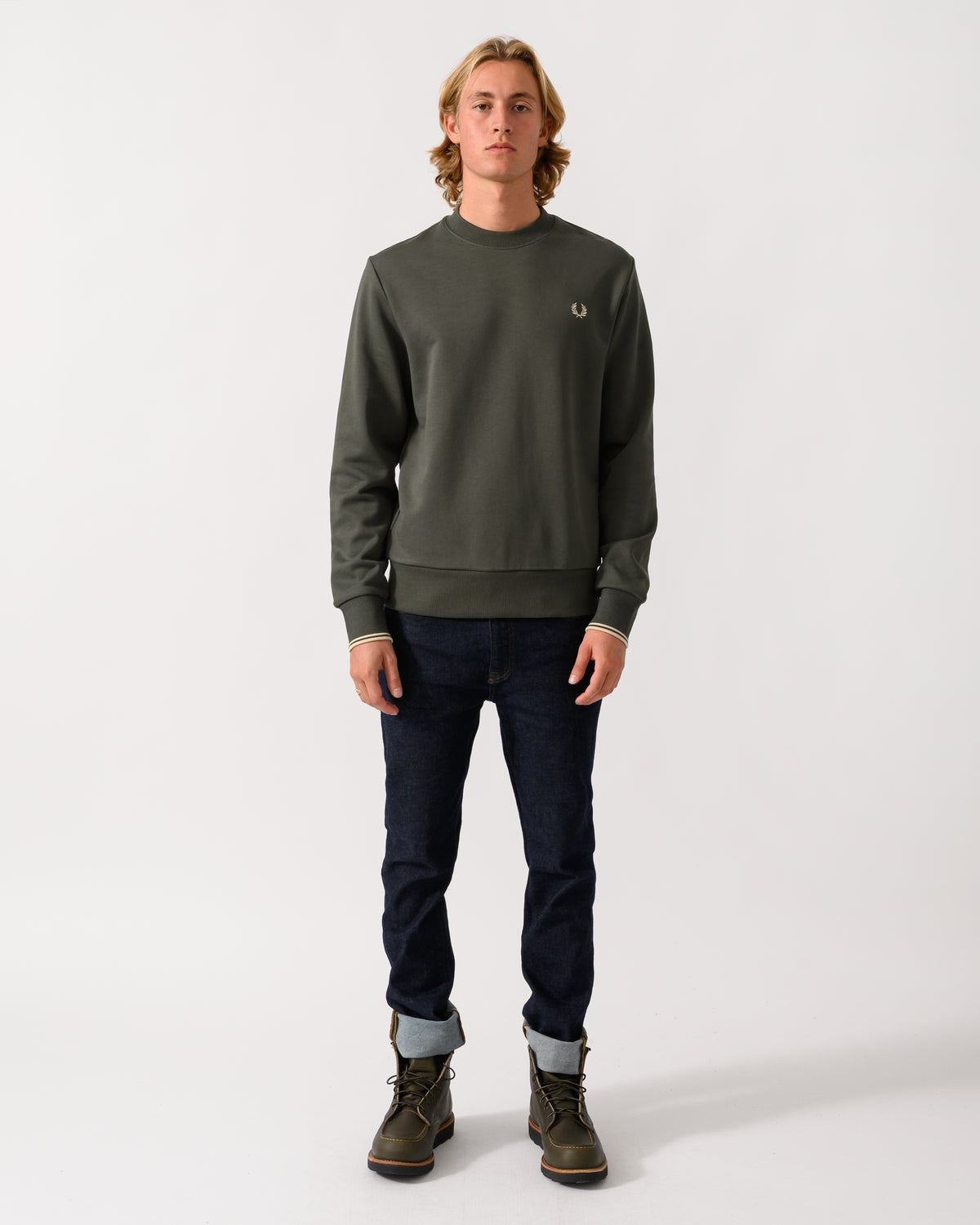 full length studio photograph of a model wearing Fred Perry Mens Crew Neck Sweatshirt in Field Green/Oatmeal U98