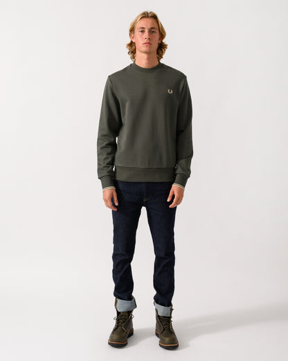 full length studio photograph of a model wearing Fred Perry Mens Crew Neck Sweatshirt in Field Green/Oatmeal U98