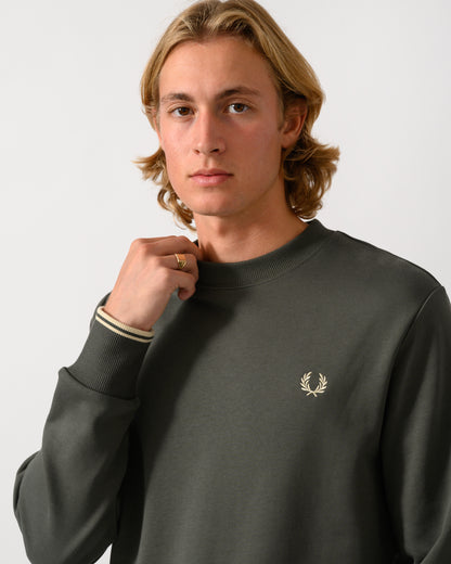 close up studio photograph of a model wearing Fred Perry Mens Crew Neck Sweatshirt in Field Green/Oatmeal U98