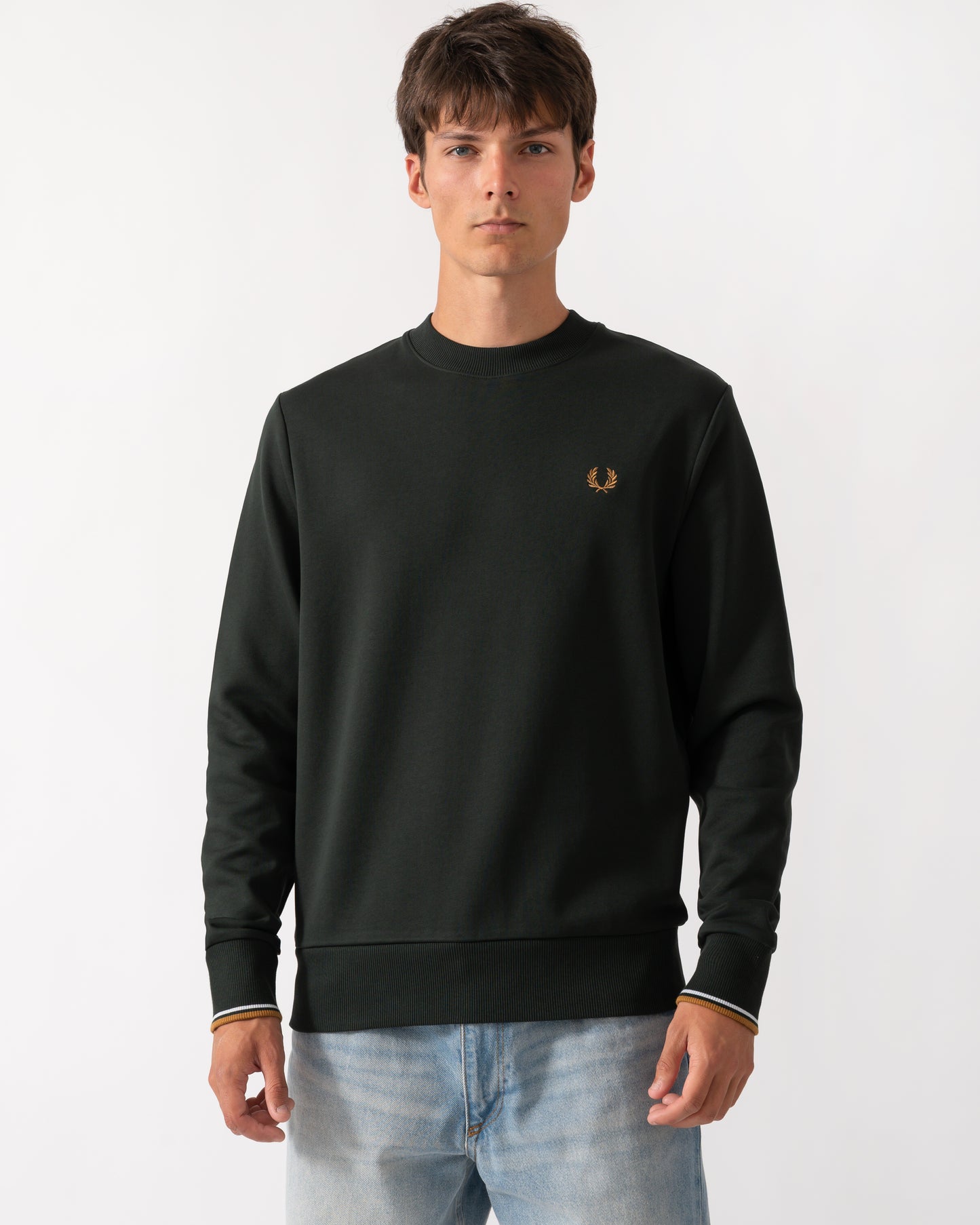 model wearing a Fred Perry Mens Crew Neck Sweatshirt in Night Green with Dusk Blue and Dark Caramel trim