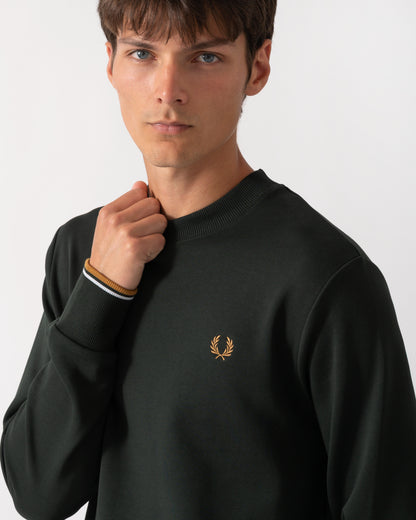 close up of a model wearing a Fred Perry Mens Crew Neck Sweatshirt in Night Green with Dusk Blue and Dark Caramel trim