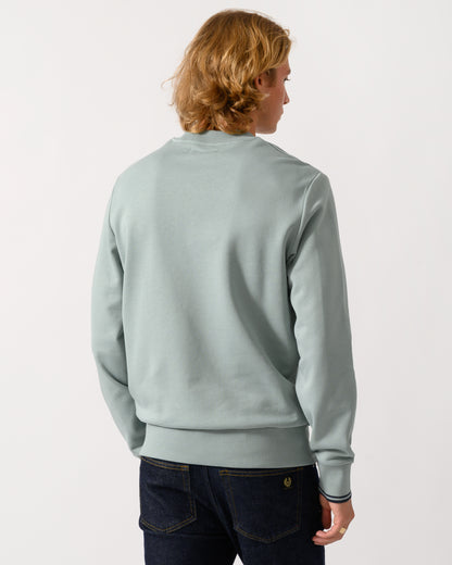 studio photograph showing back of a model wearing a Fred Perry Mens Crew Neck Sweatshirt in Silver Blue/Dark Airforce 71C