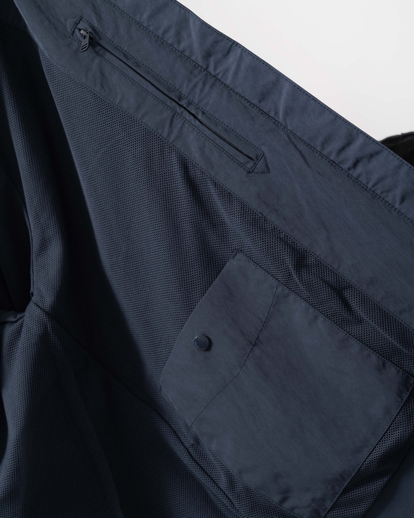 Inside pockets and mesh details of Fred Perry Mens Crinkle Nylon Harrington Jacket - Dark Airforce 738