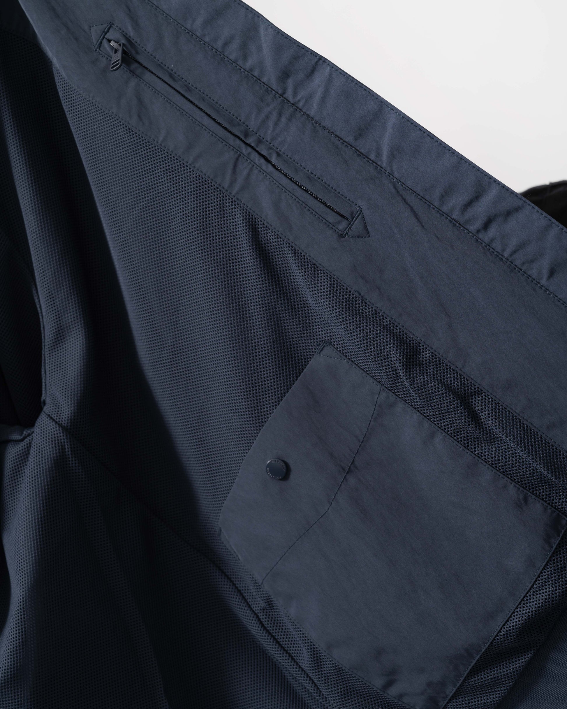 Inside pockets and mesh details of Fred Perry Mens Crinkle Nylon Harrington Jacket - Dark Airforce 738