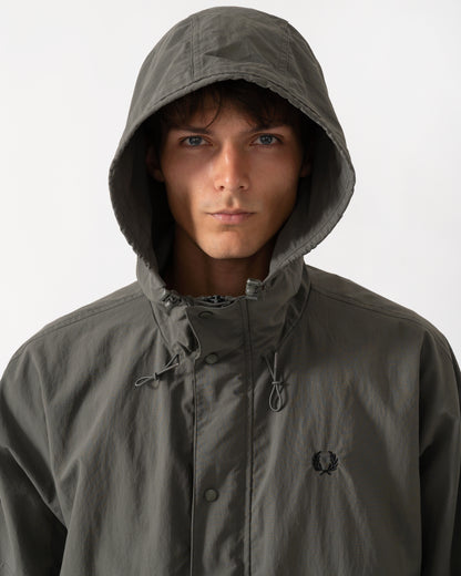 hood detail of a model wearing a Fred Perry Mens Cropped Ripstop Parka in Field Green D09