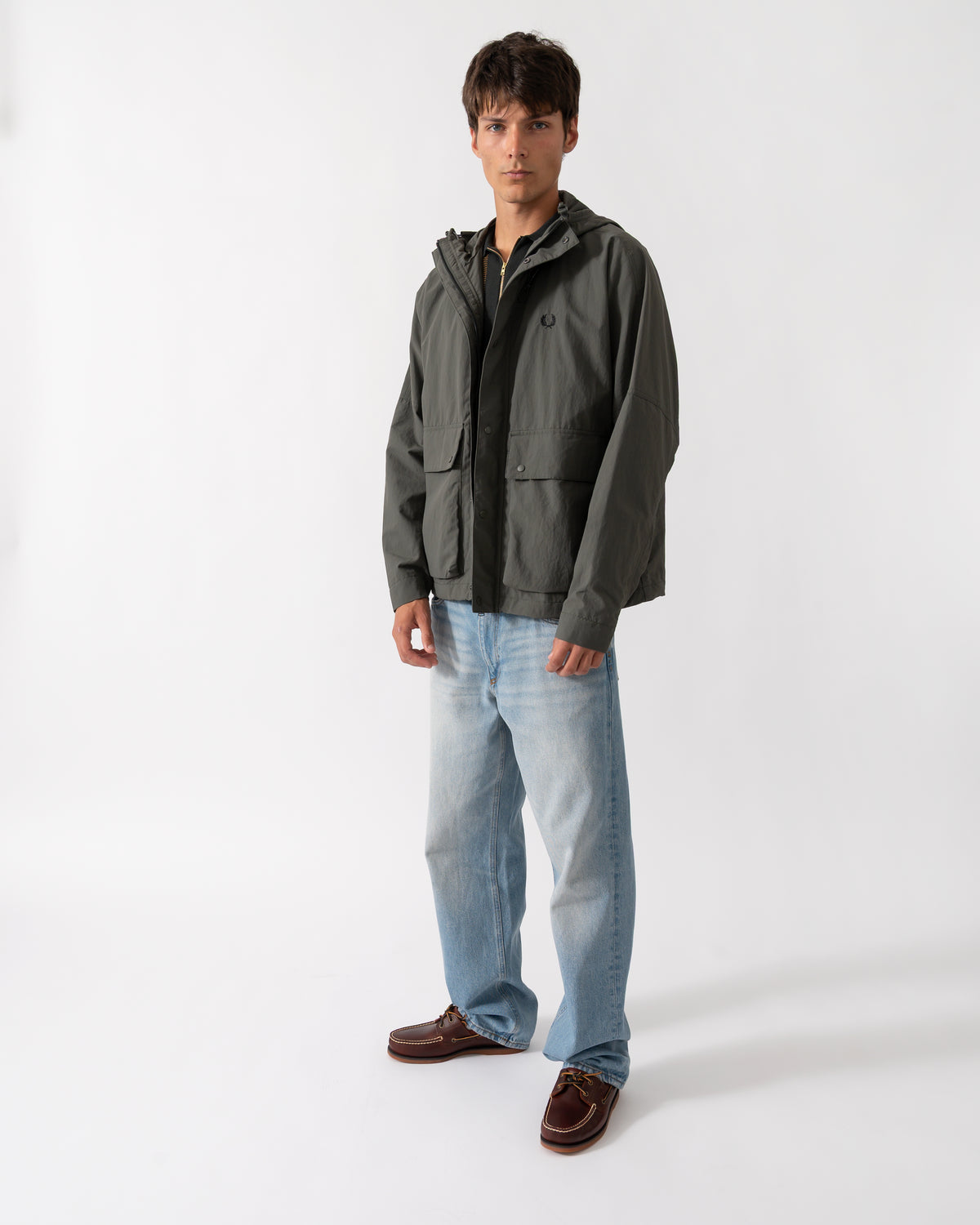 full length shot of a model wearing a Fred Perry Mens Cropped Ripstop Parka in Field Green D09