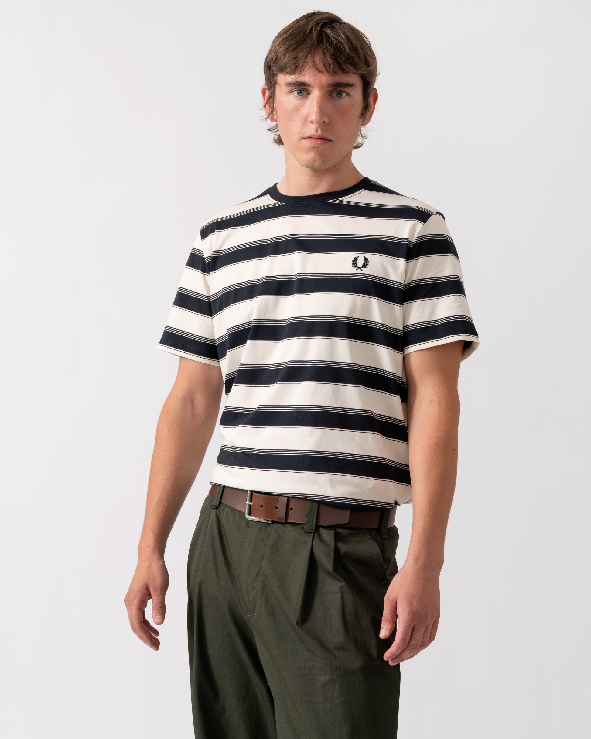 model wearing a Fred Perry Mens Fine Stripe T-Shirt in Navy 608