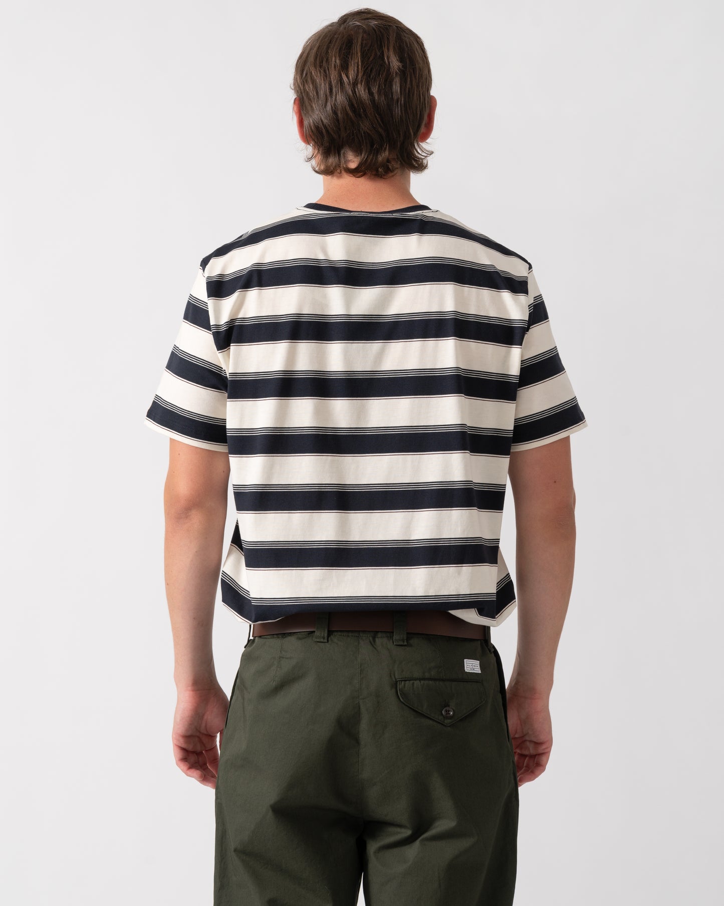 back of a model wearing a Fred Perry Mens Fine Stripe T-Shirt in Navy 608