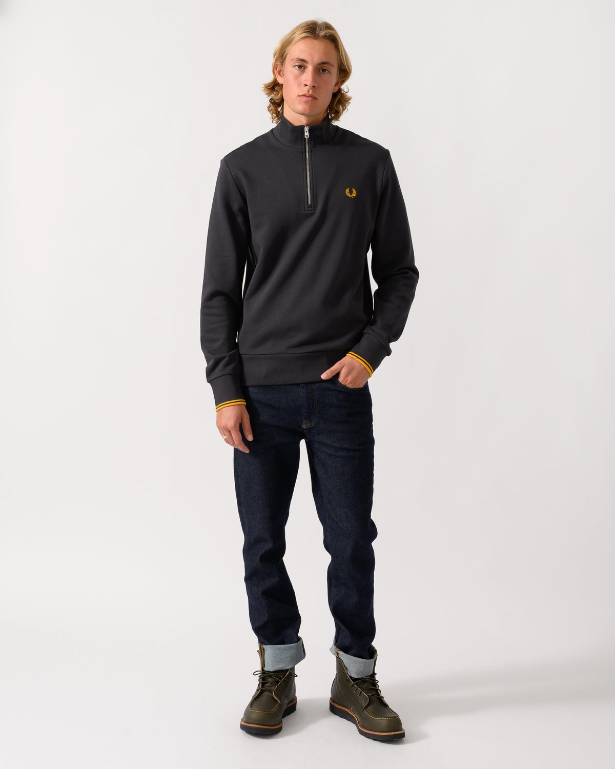 full length studio photograph of a model wearing a Fred Perry Mens Half Zip Sweatshirt in Anchor Grey/Golden 85C