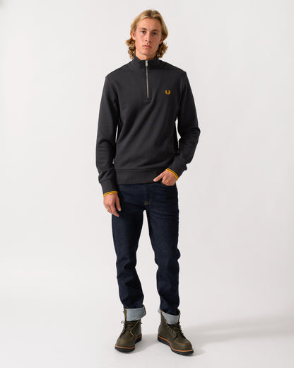 full length studio photograph of a model wearing a Fred Perry Mens Half Zip Sweatshirt in Anchor Grey/Golden 85C