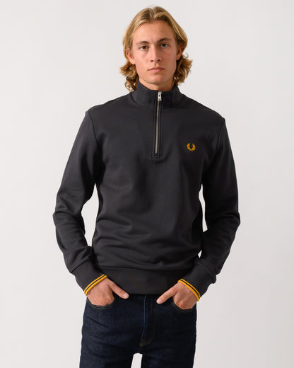 studio photograph of a model wearing a Fred Perry Mens Half Zip Sweatshirt in Anchor Grey/Golden 85C