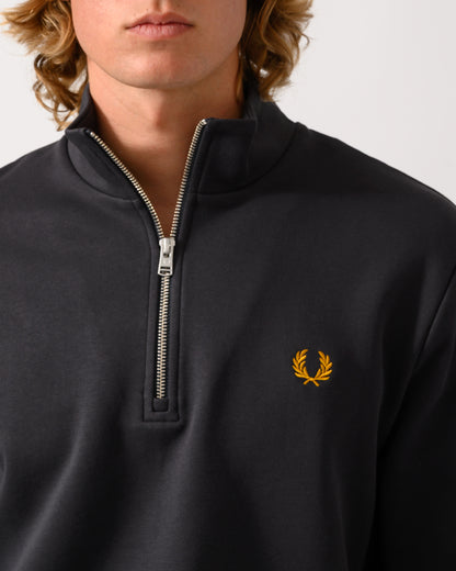 close up studio photograph of a model wearing a Fred Perry Mens Half Zip Sweatshirt in Anchor Grey/Golden 85C