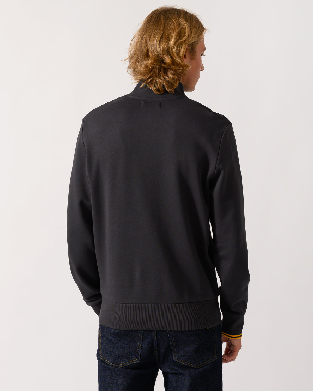 studio photograph showing back of a model wearing a Fred Perry Mens Half Zip Sweatshirt in Anchor Grey/Golden 85C
