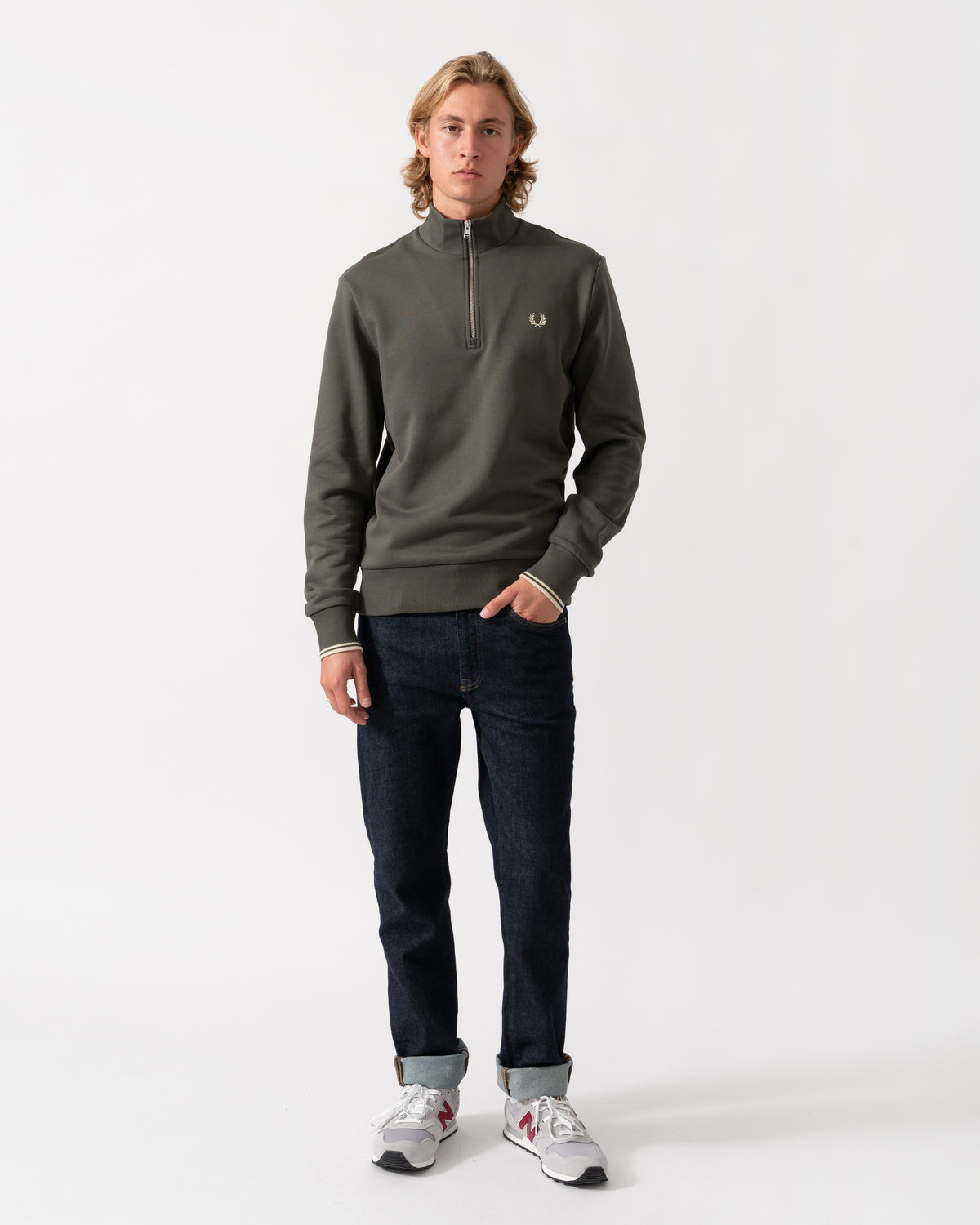 Man wearing the Fred Perry Mens Half Zip Sweatshirt - Field Green/Oatmeal U98