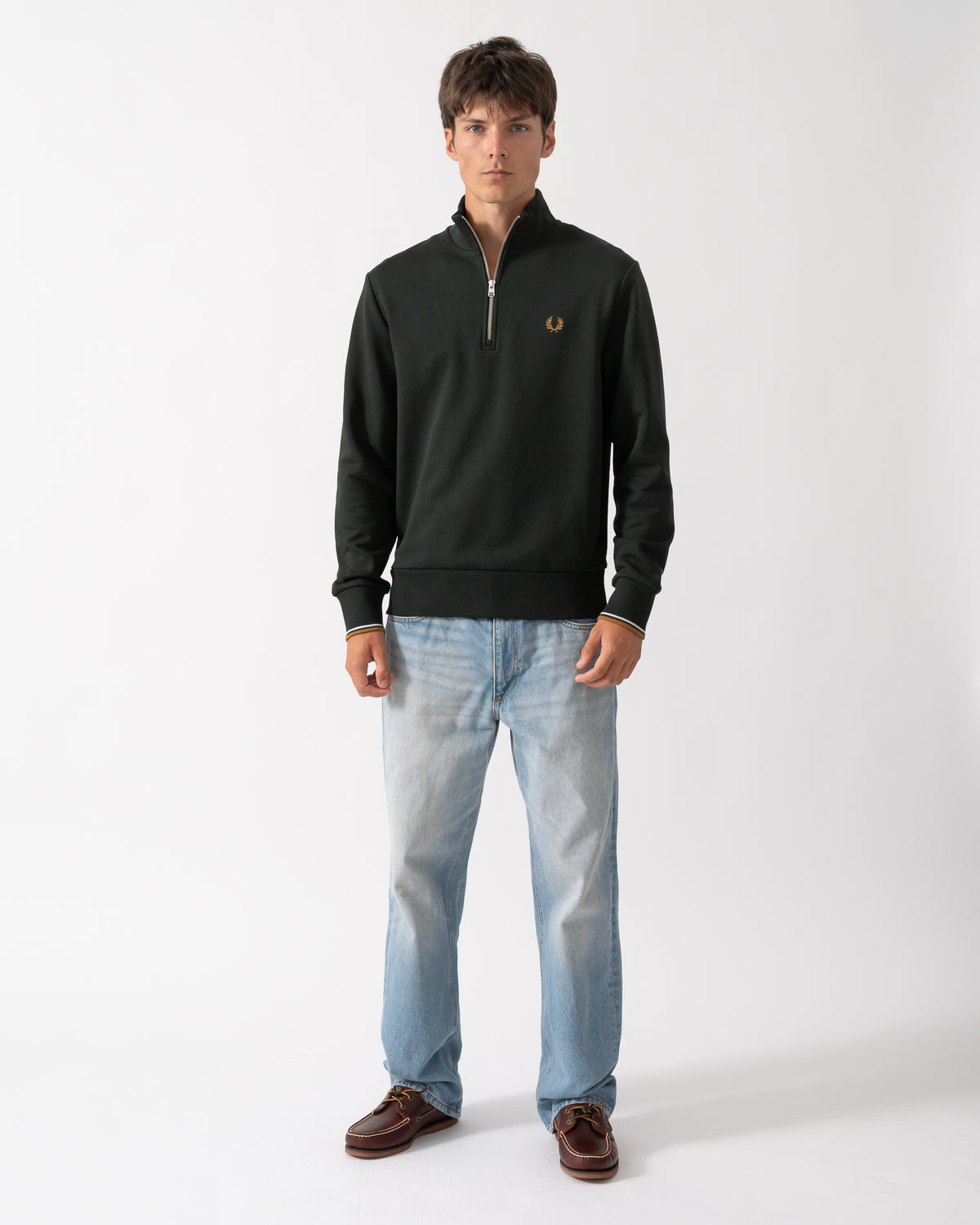 full length shot of a model wearing a Fred Perry Mens Half Zip Sweatshirt in Night Green, with Dusk Blue and Dark Caramel trim