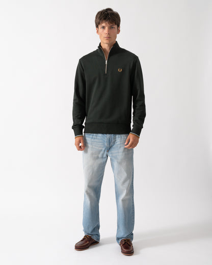 full length shot of a model wearing a Fred Perry Mens Half Zip Sweatshirt in Night Green, with Dusk Blue and Dark Caramel trim