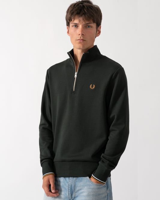 model wearing a Fred Perry Mens Half Zip Sweatshirt in Night Green, with Dusk Blue and Dark Caramel trim