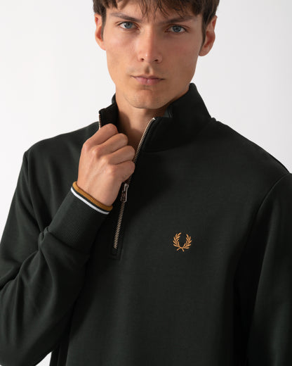 close up shot of a model wearing a Fred Perry Mens Half Zip Sweatshirt in Night Green, with Dusk Blue and Dark Caramel trim
